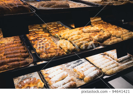 different kinds of pastry in bakery shop street window different kinds of pastry in bakery shop street window 94641421