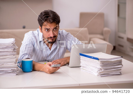 Young businessman employee working from home during pandemic Young businessman employee working from home during pandemic 94641720