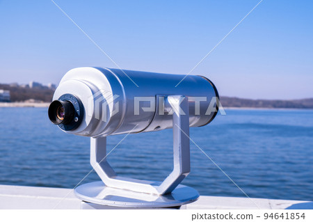 Tourist binoculars. Binocular telescope on the observation deck for tourism. Sea background. Sopot on the pier Binoculars watching at horizon at ship deck. Travel tourist destination attraction  94641854