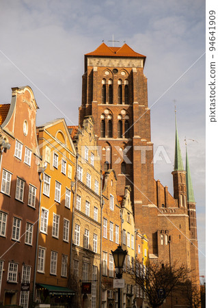 Gothic Bazylika Mariacka church Saint Mary cathedral in City hall Ancient architecture of old town in Gdansk Poland. Beautiful and colorful old houses historical part of downtown Gothic Bazylika Mariacka church Saint Mary cathedral in City hall Ancient architecture of old town in Gdansk Poland. Beautiful and colorful old houses historical part of downtown 94641909