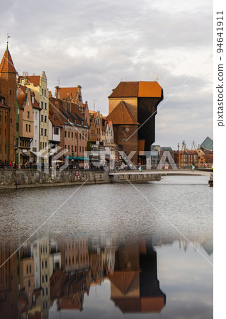 Ancient crane - zuraw Old town in Gdansk. The riverside on Granary Island reflection in Moltawa River. Visit Gdansk Poland Travel destination 94641911
