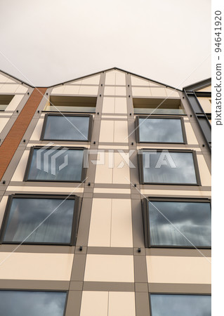Modern buildings on Granary Island over the Motlawa River in Old Town. Abstract structure. Creative photo Tourism on the Motlawa River. New Apartments architecture glass windows with reflections Modern buildings on Granary Island over the Motlawa River in Old Town. Abstract structure. Creative photo Tourism on the Motlawa River. New Apartments architecture glass windows with reflections 94641920