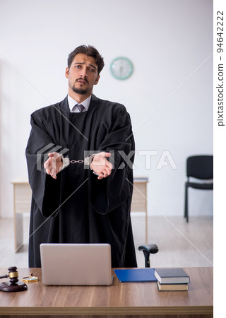 Young male judge in corruption concept 94642222