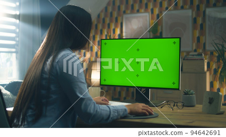Woman working remotely on pc at home 94642691