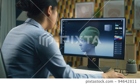 Woman making 3D design of clothes on pc Woman making 3D design of clothes on pc 94642811