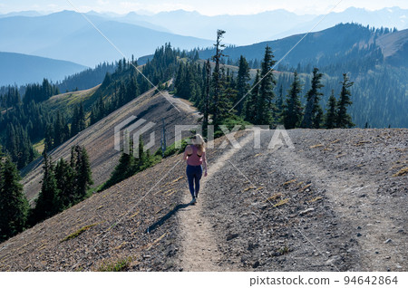 Young woman hiking in Olympic National Park, Washington. Young woman hiking in Olympic National Park, Washington. 94642864