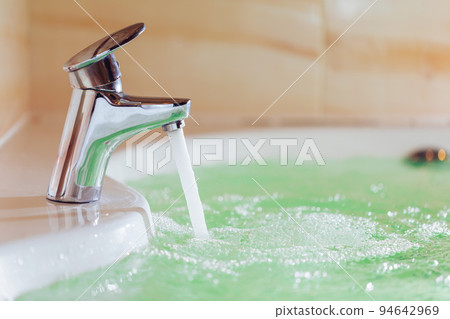 single handle faucet pouring hot water in a bath tub 94642969
