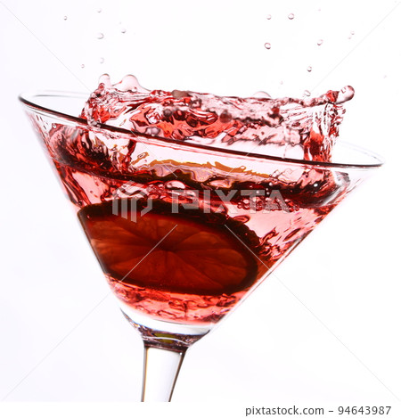 red cocktail with lime on white 94643987