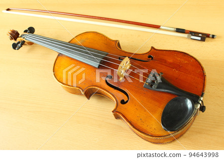 antique violin with a fiddlestick 94643998