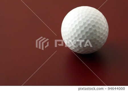 golf ball on red surface 94644000