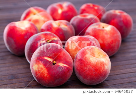 Juicy ripe peaches on wooden table Juicy ripe peaches on wooden table 94645037