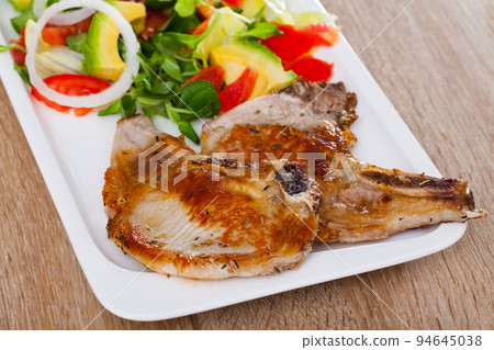Pork escalope with salad from avocado, tomatoes and corn salad Pork escalope with salad from avocado, tomatoes and corn salad 94645038