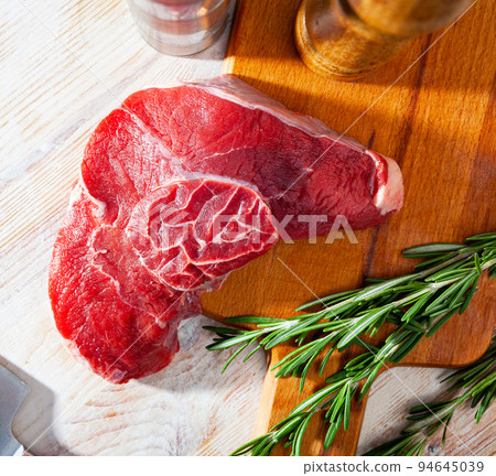Raw beef entrecote with rosemary Raw beef entrecote with rosemary 94645039