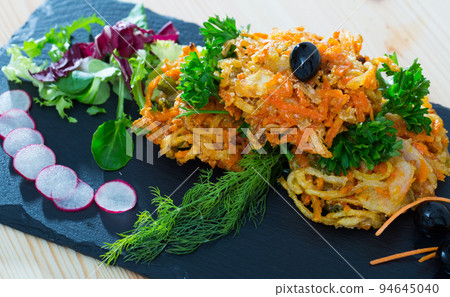 Tasty fried carrots cutlets with greens served at plate on table Tasty fried carrots cutlets with greens served at plate on table 94645040