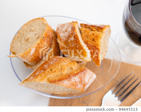 Sliced baguette in glassy plate Sliced baguette in glassy plate 94645513