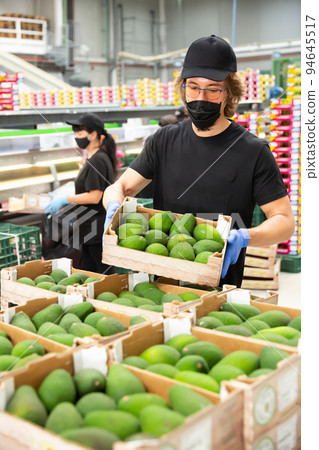 Adult male warehouse worker loading boxes 94645517
