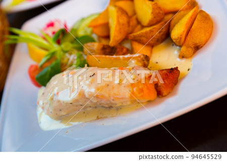 Photography of plate with salmon with sauce and potatoes 94645529