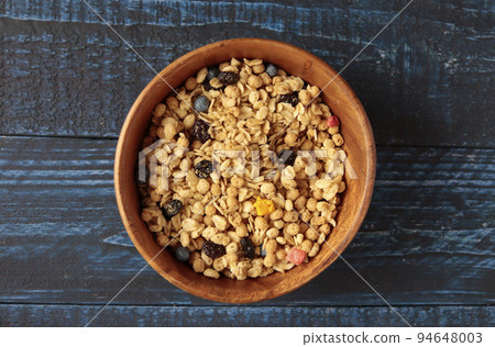 Fruit granola with kid's favorite dried fruits like corn flakes and cereal on the table Fruit granola with kid's favorite dried fruits like corn flakes and cereal on the table 94648003