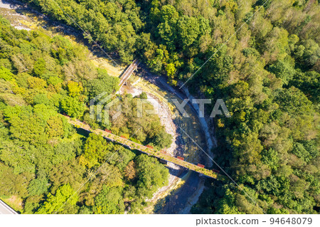Drone photography | Concrete arch bridge through the forest | No. 5 Otofuke River Bridge on the former Japanese National Railways Shihoro Line | Kamishihoro Town, Hokkaido 94648079