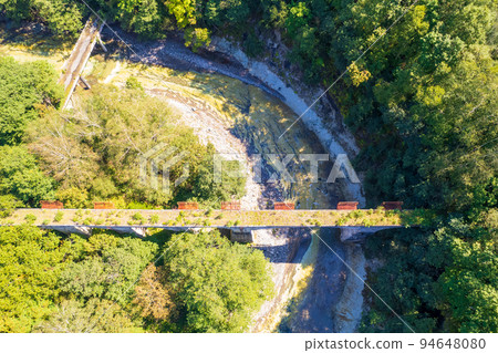Drone photography | Concrete arch bridge through the forest | No. 5 Otofuke River Bridge on the former Japanese National Railways Shihoro Line | Kamishihoro Town, Hokkaido 94648080