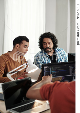 Programmers discussing new releasing new feature on website 94648925