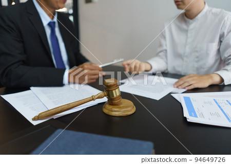 Lawyer and legal concept, Businessman receives a pen from senior lawyer to signing contract Lawyer and legal concept, Businessman receives a pen from senior lawyer to signing contract 94649726