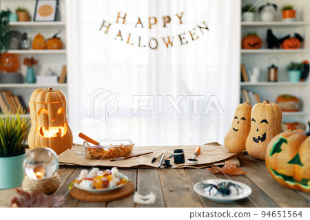 Carving pumpkin on the table at home Carving pumpkin on the table at home 94651564