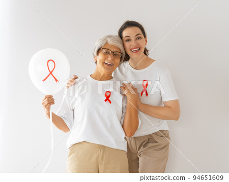 Smiling women with red satin ribbon 94651609