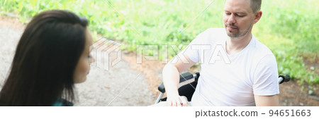 A man in a wheelchair in makes notes A man in a wheelchair in makes notes 94651663