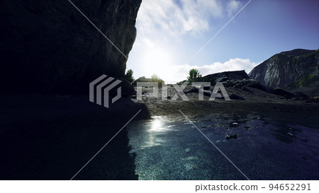 small sand ocean beach near rocky cliff 94652291