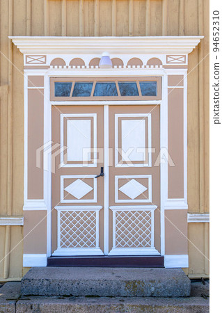 The detail of colorful decorated historic wooden entrance door of old house in Sweden The detail of colorful decorated historic wooden entrance door of old house in Sweden 94652310