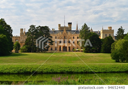 Lednice Chateau with beautiful gardens and parks on sunny summer day. Lednice-Valtice Landscape, South Moravian region. UNESCO World Heritage Site. Beautiful old romantic castle. Lednice Chateau with beautiful gardens and parks on sunny summer day. Lednice-Valtice Landscape, South Moravian region. UNESCO World Heritage Site. Beautiful old romantic castle. 94652440