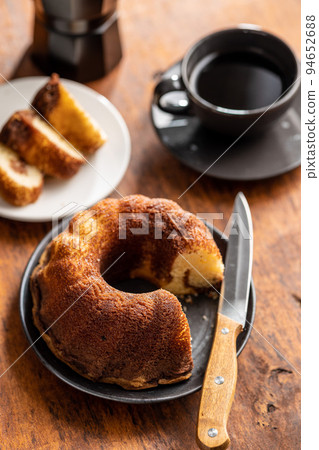 Sweet sponge cake. Bundt cake on wooden table. Sweet sponge cake. Bundt cake on wooden table. 94652688