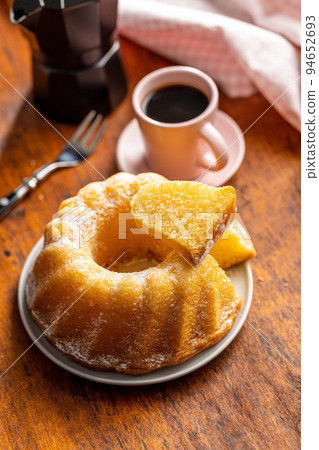 Sweet sponge cake. Bundt cake on wooden table. Sweet sponge cake. Bundt cake on wooden table. 94652693