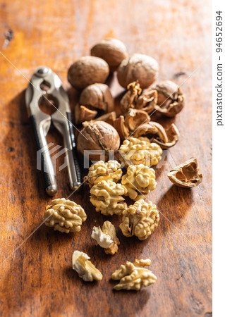 Peeled walnut on wooden table. Peeled walnut on wooden table. 94652694