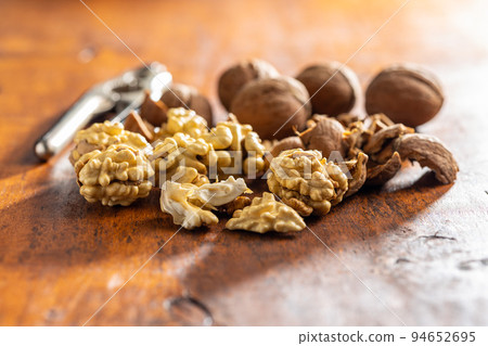 Peeled walnut on wooden table. Peeled walnut on wooden table. 94652695