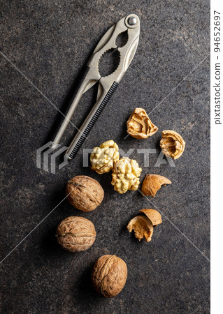 Peeled walnut on dark table. Peeled walnut on dark table. 94652697
