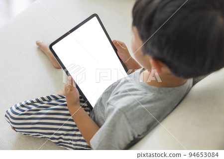 Close-up adorable happy Asian boy hand held use finger touches with digital tablet white screen isolated on white background. Concept of technology, connection, communication, social. Close-up adorable happy Asian boy hand held use finger touches with digital tablet white screen isolated on white background. Concept of technology, connection, communication, social. 94653084