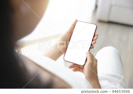 Close-up woman of Left hand held, right hand use finger touches with digital smartphone white screen isolated on white background. Concept of technology, connection, communication, social. 94653098