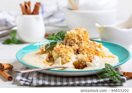 Apple crumble with custard. 94653202