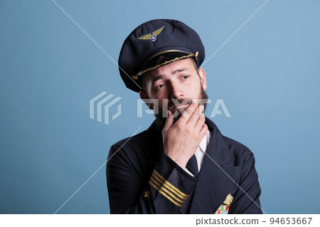Pensive thoughtful airline capitan in uniform questioning, making decision, thinking, making choice. Pensive plane pilot with doubtful uncertain facial expression portrait 94653667