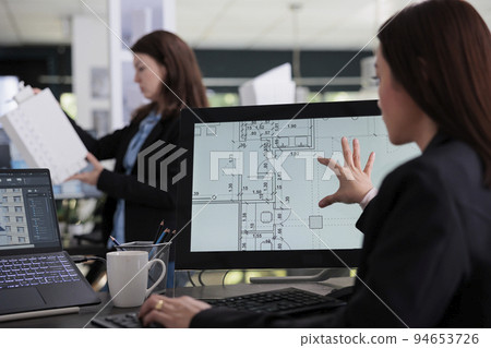 Woman working in room floor planner software, zooming in project draft, designing interior in 2d creator app back view. Cad, blueprints on computer monitor screen, designer plan. 94653726