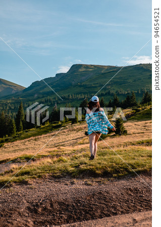 woman enjoying sunset above the mountains 94654521