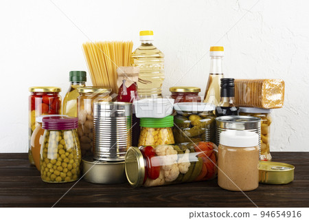 Emergency survival food set on dark wooden kitchen table 94654916