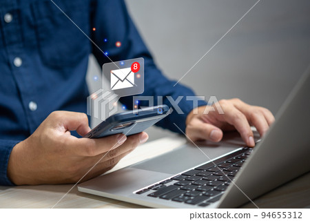 businessman holding hand touchscreen smartphone and checking email icon online or sending mail to partner and customer on web with virtual interface technology concept. 94655312