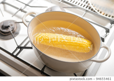 Cooking scene boiling corn Cooking scene boiling corn 94655461