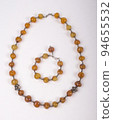 Set of necklace and bracelet made of brown colored stone decorated by silver 94655532