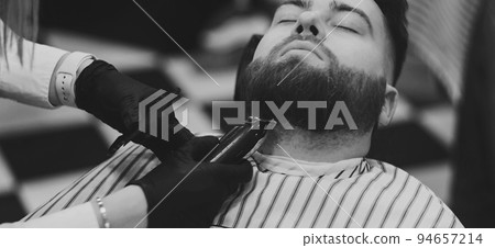 Barber cutting beard of male client Barber cutting beard of male client 94657214