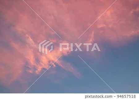 pink sunset clouds in the blue sky 94657518