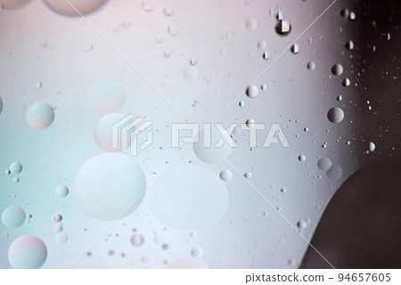Defocused pastel and dark colored abstract background picture made with oil, water and soap Defocused pastel and dark colored abstract background picture made with oil, water and soap 94657605